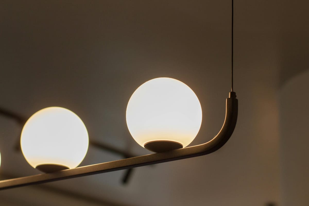 Luminária com globos de vidro e acabamento metálico da Artemide